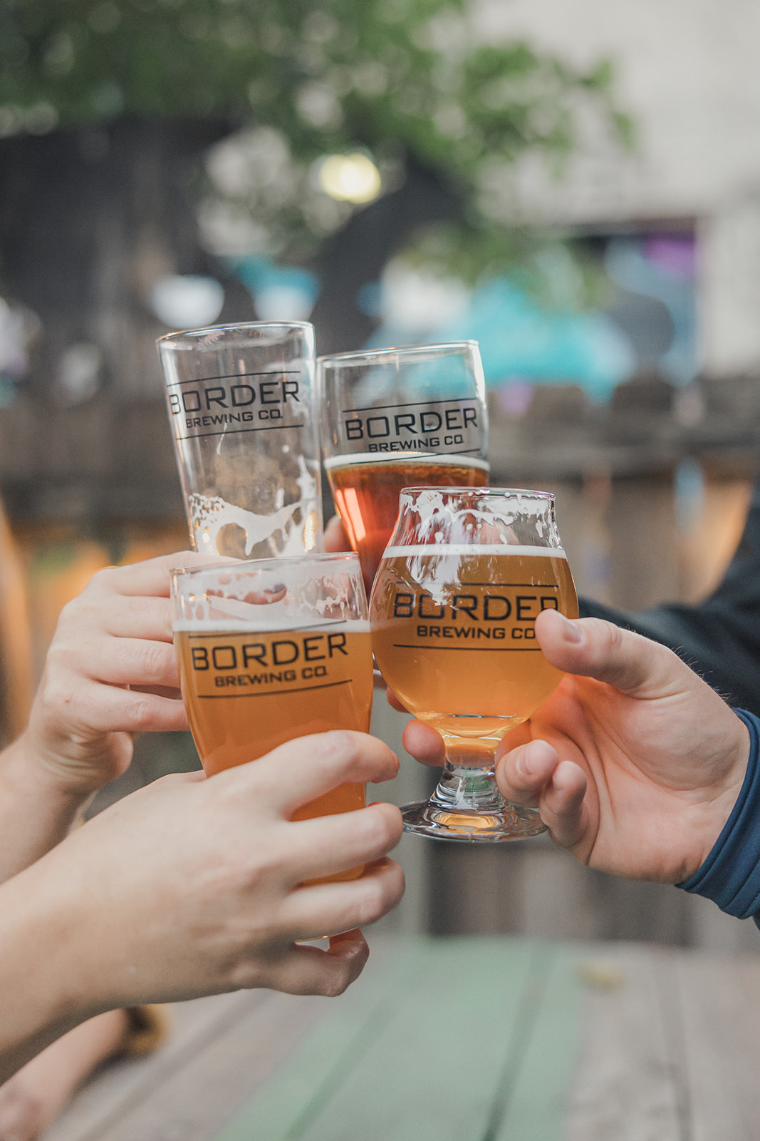 Friends toasting drinks at Border Brewing Company in Kansas City