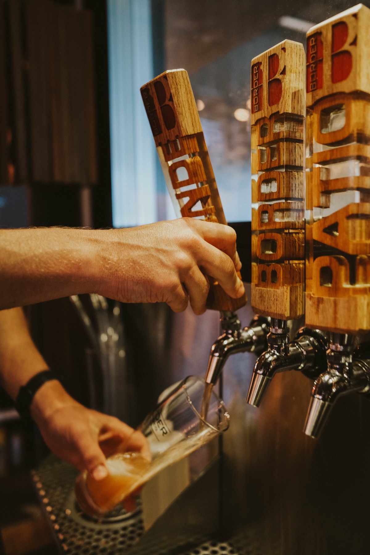 Bartender pouring a draft beer at Border Brewing Company
