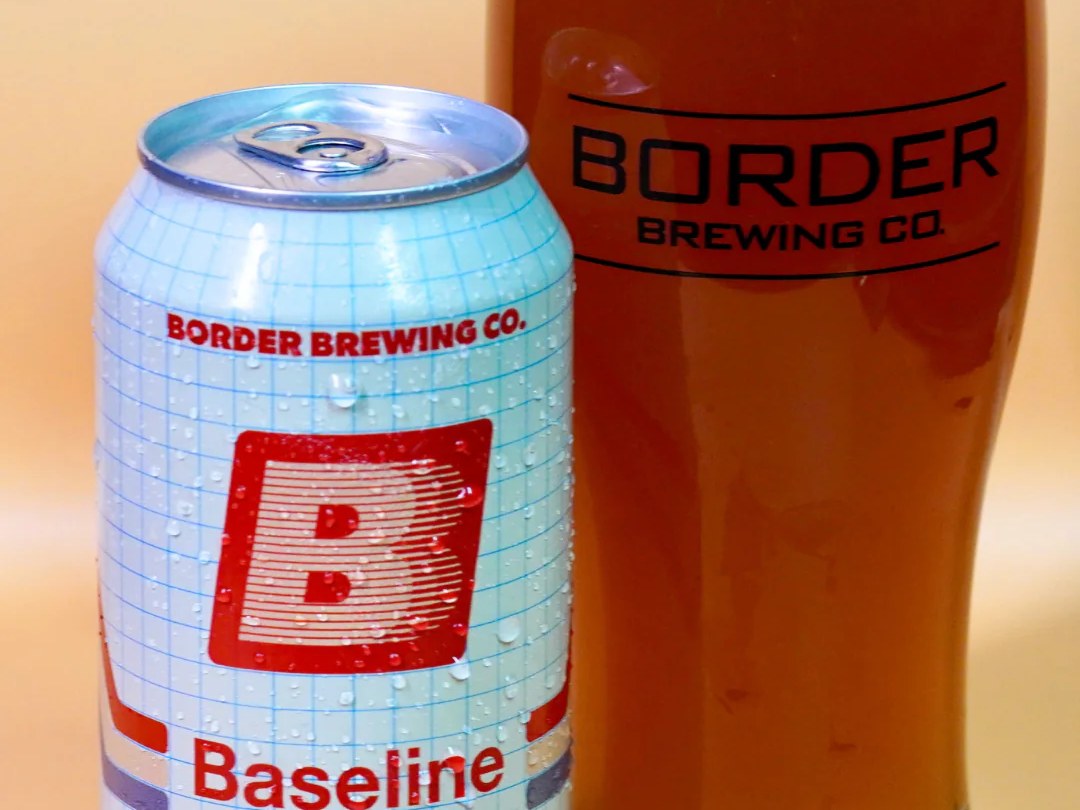 Baseline Amber NA — a 12 oz can next to a Border Brewing pint glass filled with amber beer