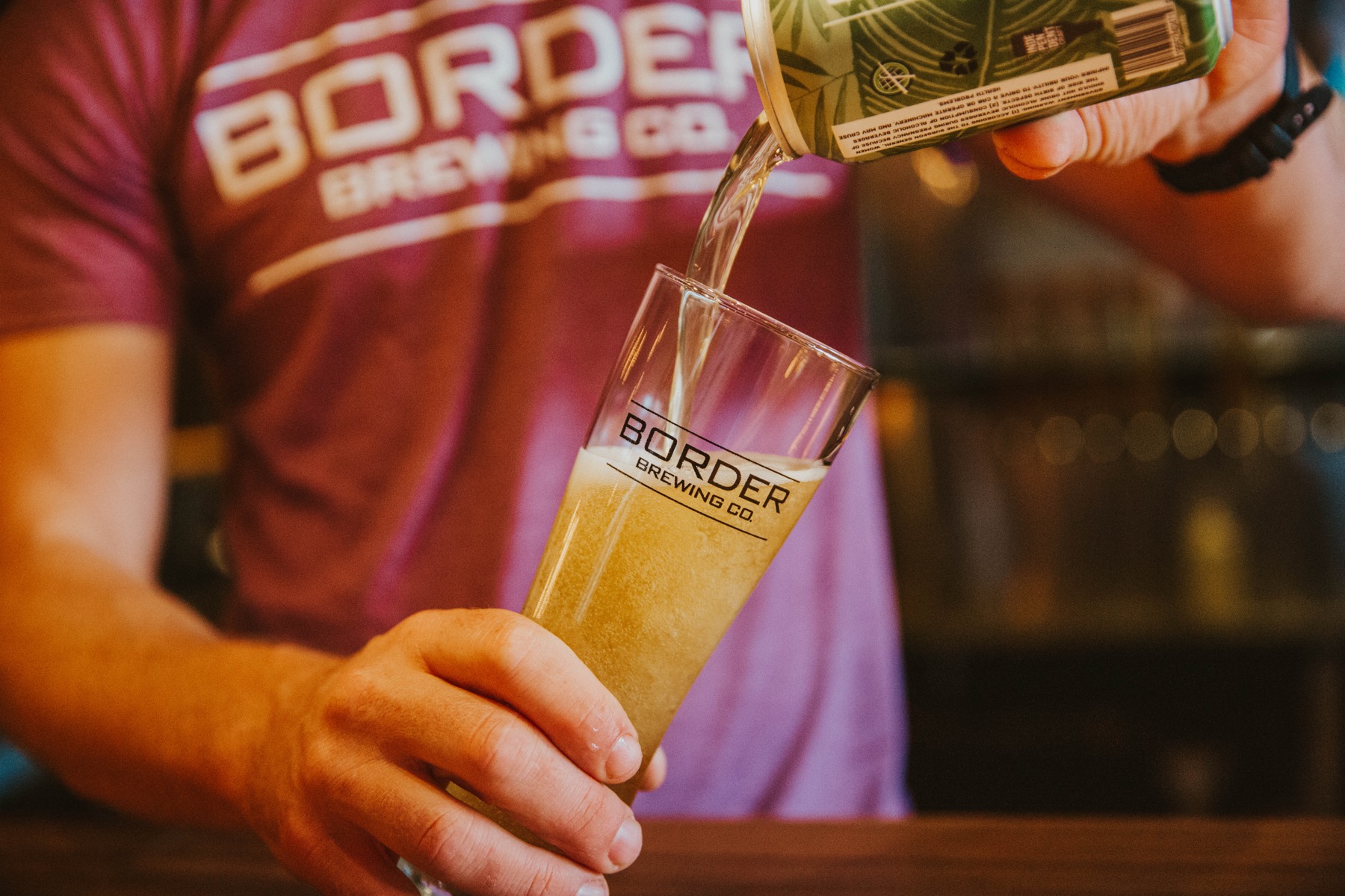 A bartender pouring the LIma Fresca into a glass for a customer in the Crossroads Art District in Kansas City, MO