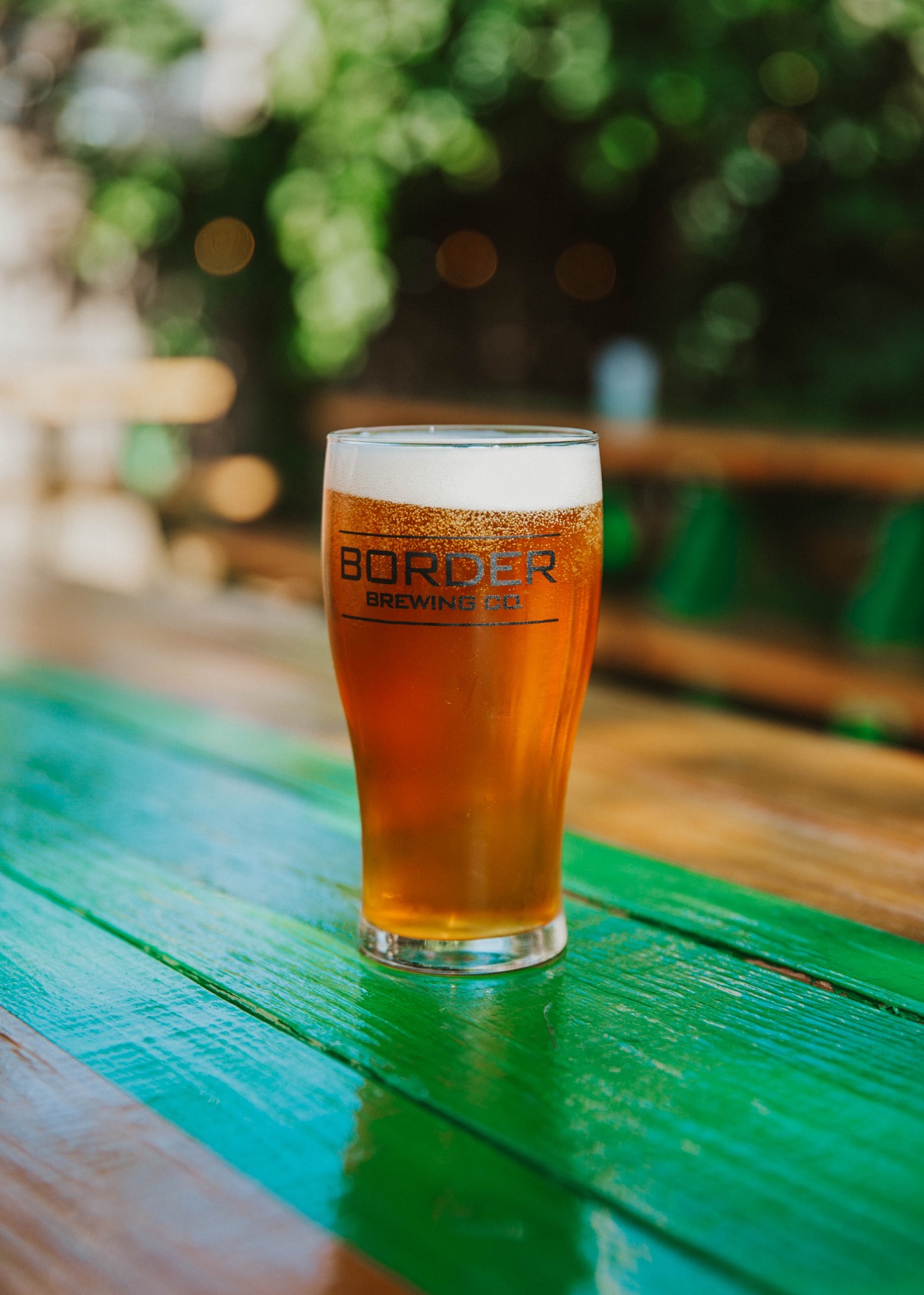 Easy Landing IPA in a glass on a patio table at Border Brewing Company in Kansas City